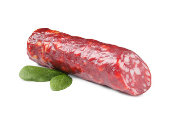 Piece of delicious dry cured sausage with basil isolated on white