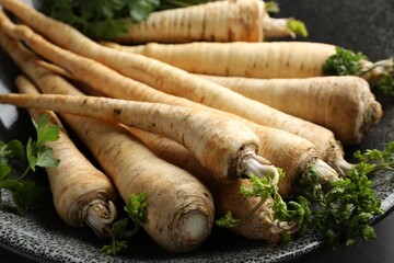 Parsley roots with leaves on table, closeup