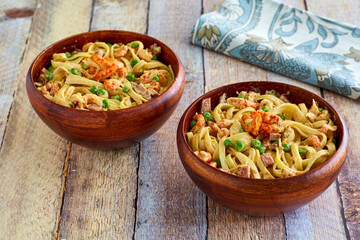 cajun style seafood alfredo pasta served in bowls