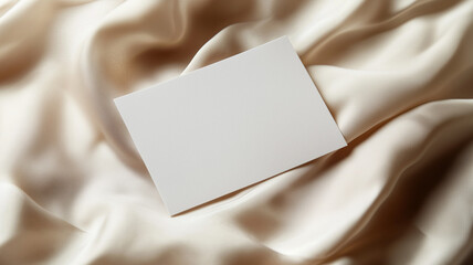Fototapeta premium A blank card placed on a soft beige fabric