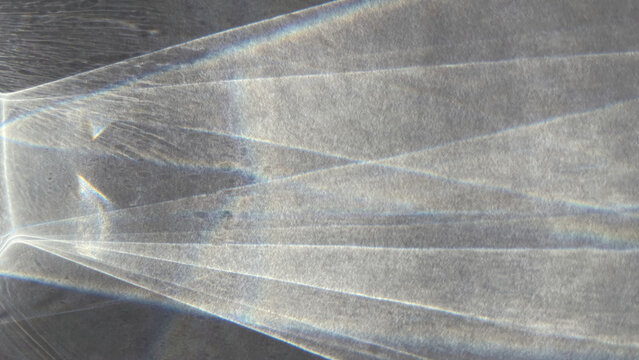 Sunlight casting on a white paper surface trough clear glass. Light refraction, dispersion of light, realistic shadows, 4k UHD, 16:9 ratio. For overlay, multiply, screen Blend Modes for mockups.