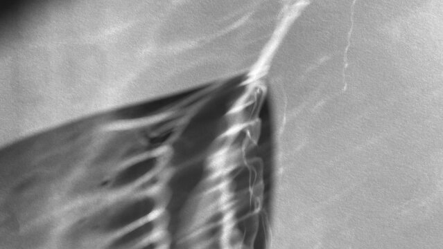 Sunlight casting on a white paper surface trough clear glass. Light refraction, dispersion of light, realistic shadows, 4k UHD, 16:9 ratio. For overlay, multiply, screen Blend Modes for mockups.