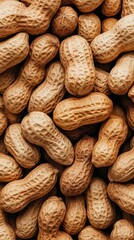 Freshly harvested peanuts scattered on a rustic surface showcasing their natural textures and shades in a sunny setting
