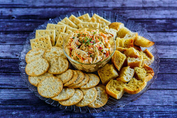 spicy crab salad served with bread and crackers