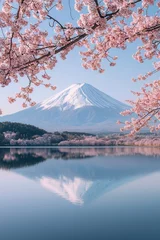 Cherry blossoms framing Mount Fuji, serene landscape reflecting in water, tranquil spring scenery in Japan, nature photography, travel destinations.