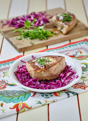 wasabi seared tuna steak served on a bed of red cabbage
