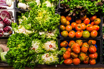 Fresh Vegetables at the Market - A vibrant display of fresh vegetables at a local market. Green...