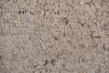 Ancient stone wall background with antique text