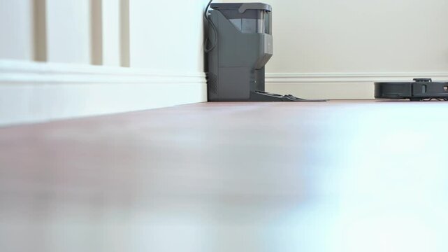 Robot vacuum cleaner vacuuming the floor in the bedroom. Smart home with automated devices that simplify life. A smart vacuum cleaner cleans the floor. High quality 4k footage