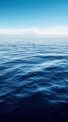 Fototapeta premium Tranquil ocean view with gentle waves under a clear blue sky, evoking serenity and peace