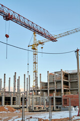 construction site and a big crane on the background blue sky