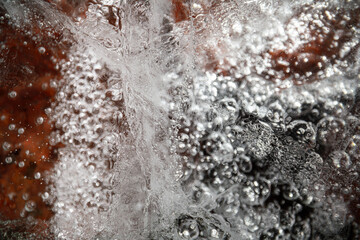 Ice surface, texture with cracks, bubbles and frozen leaves for computer graphics, texturing, compositing or as a background