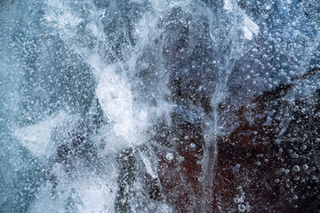 Ice surface, texture with cracks, bubbles and frozen leaves for computer graphics, texturing, compositing or as a background