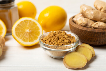 Fresh ginger on wooden background. Dry ginger. Sliced ​​ginger with honey and lemon. Ginger root. Traditional alternative medicine, healing tea for immunity. Seasoning and spices concept. Copy space.