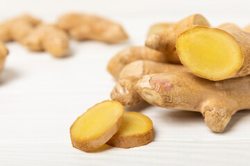 Fresh ginger on wooden background. Dry ginger. Sliced ​​ginger with honey and lemon. Ginger...