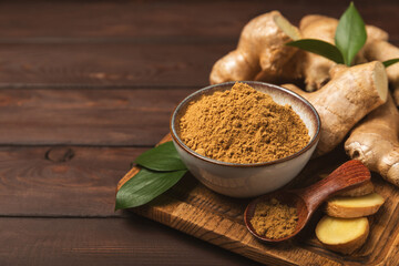 Fresh ginger on wooden background. Dry ginger. Sliced ​​ginger with honey and lemon. Ginger...