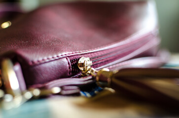 Handbag with a dark pink fabric. Metal zipper and gold hardware