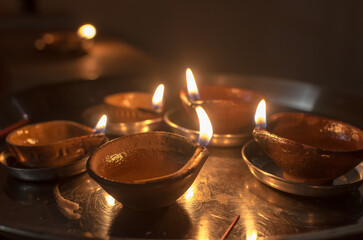 Lighting lamps, oil diyas and decoration during Deepawali festival, Diwali