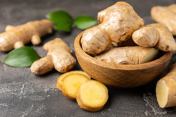 Fresh ginger on wooden background. Dry ginger. Sliced ​​ginger with honey and lemon. Ginger root. Traditional alternative medicine, healing tea for immunity. Seasoning and spices concept. Copy space.
