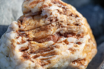 Textured quartz stone with orange iron inclusions in extra close-up