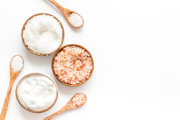 Different kind of sea salt in wooden bowls with spoon, top view. Salt for spa, salt baths or cooking