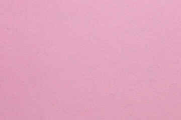 A pink background with a white object in the middle, textured origami paper backdrop