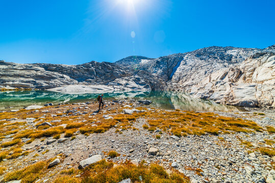 Person Hiking Near Pristine Alpine Lake