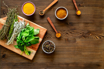 Cooking table with fresh green herbs and spices. Healthy food background