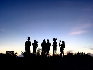 silhouette of people again sunset