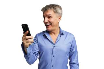 Man smiles while looking at smartphone, showing excitement in a bright setting