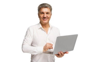 Smiling man holding a laptop while standing against a plain background in a bright, professional setting