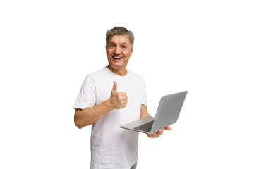 Older man expressing joy while holding a laptop and giving a thumbs up in a bright setting