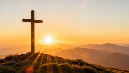 Cross at sunrise over mountain landscape