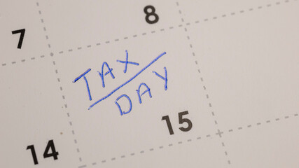 Calendar reminder for the tax deadline, handwritten in blue on the 15th day. Important financial...
