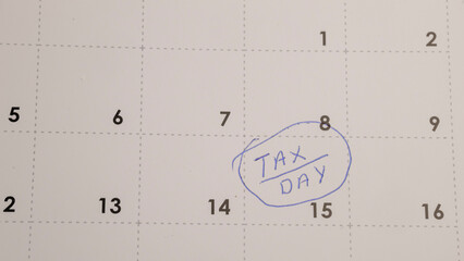Tax Day Reminder: Calendar date circled in blue marker.  Deadline for filing income taxes, planning finances, and managing obligations. Deadline on a calendar.