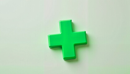 Fototapeta premium Simple green cross on clean surface, symbol of health and care