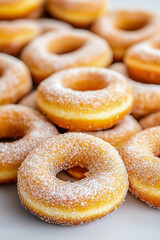 A close up of powdered donuts with a white background