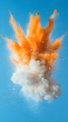 Fototapeta premium Bright orange and white powder explosion against a clear blue sky creating an artistic display