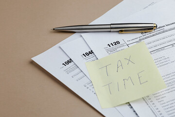 Tax Season Paperwork with Reminder Note
