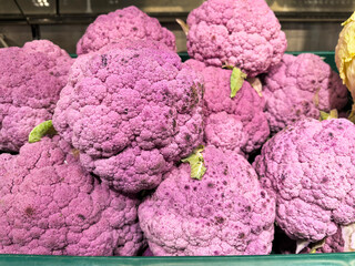 Purple cauliflower lies on the counter of the farmer's market and store. Vegetable dishes, healthy...