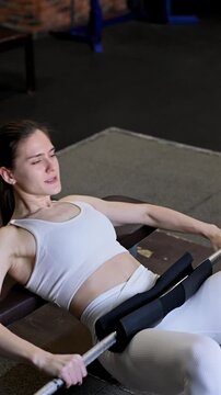 Caucasian woman doing glute bridge with barbell. hip thrust. 