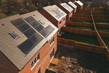 Aerial view of New residential houses fitted with solar panels in a suburban neighborhood during...