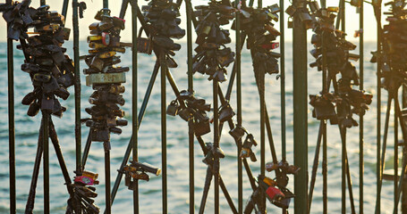 Detail of many love locks on the fence of Thessaloniki seafront promenade