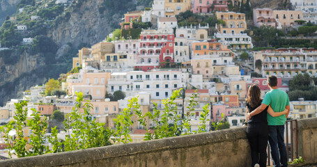 Lovers couple admiring the picturesque panorama Positano on Amalfi coast, Italy