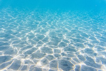 Sunlit patterns on the sandy bottom of the clear Caribbean waters in Saint Lucia