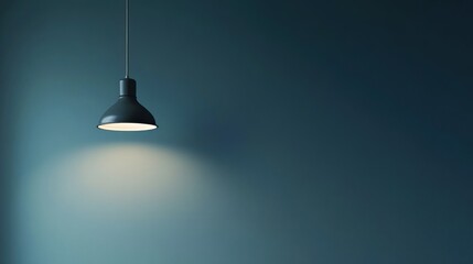 Illuminated Minimalism: A Single Pendant Lamp Against a Teal Wall