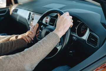 Naklejka premium Learning to drive with guidance from passenger in parked car during the day
