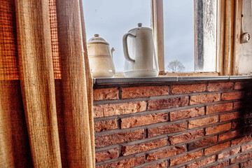 Abandoned far - old wooden window with brick wall