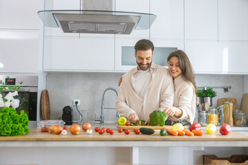 A lovely couple connecting through cooking, surrounded by fresh ingredients in a trendy kitchen represents a healthy lifestyle.
