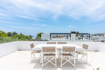 an image of a private rooftop terrace with dining table overlooking the coastline of Marbella 